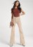 Venus Corduroy Flared Pants in Cream